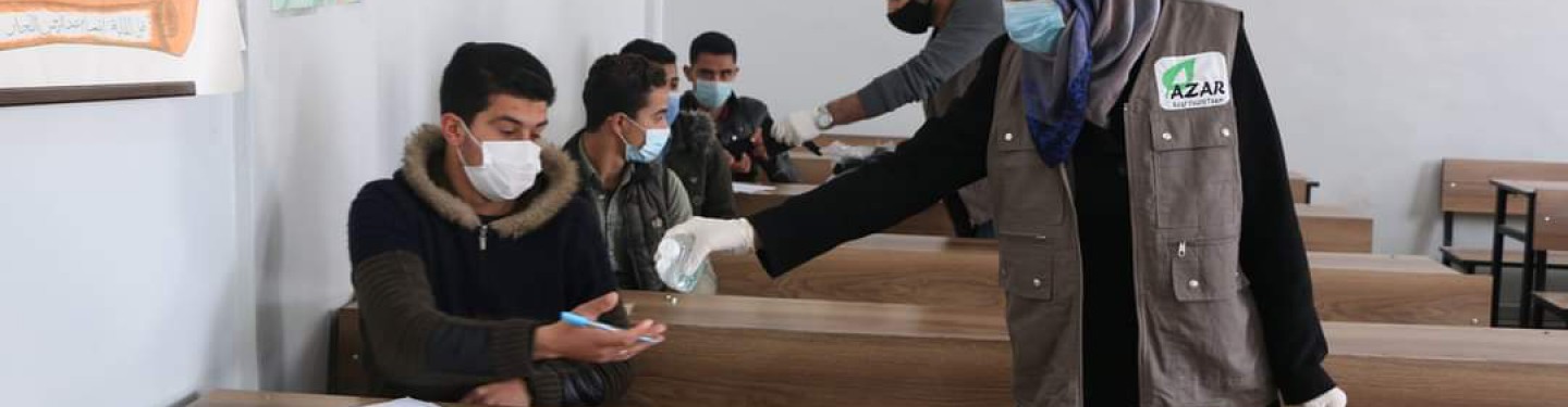 In cooperation with the Free University of Aleppo, student volunteers distribute medical masks and hand sanitizer to students sitting for exams. March 2021. Credits: Free University of Aleppo